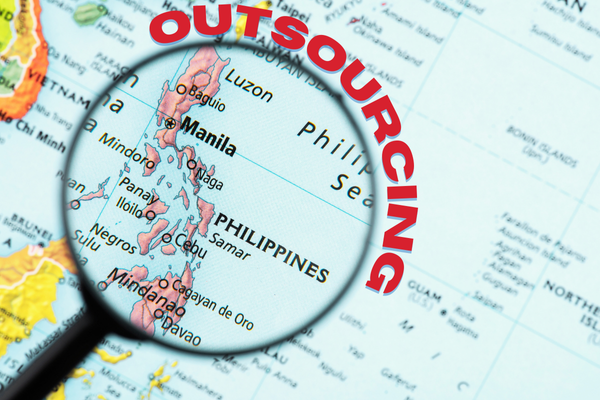 A detailed map of the Philippines with a magnifying glass focusing on Manila and surrounding areas, emphasizing the strategic importance of the Philippines for outsourcing services. This visual highlights the geographical context relevant to the keyword 'Philippines outsourcing.