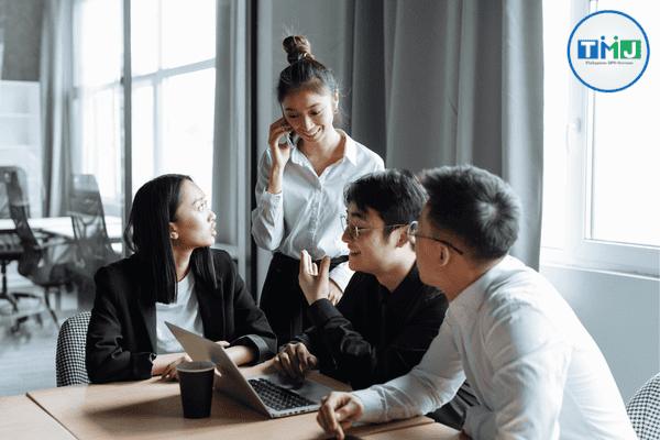 A professional team discussing business strategies in a modern office environment, representing the collaborative workforce of outsourcing in the Philippines.